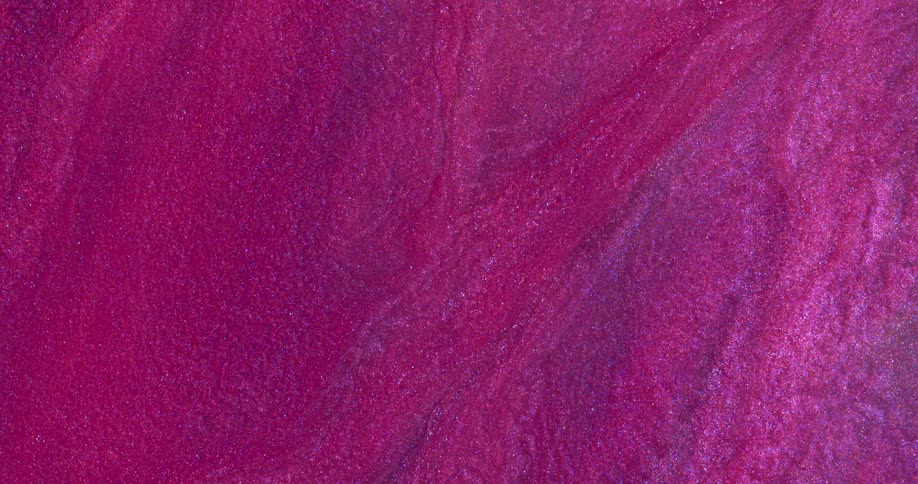 Macro close up of swirling metallic shimmer inks