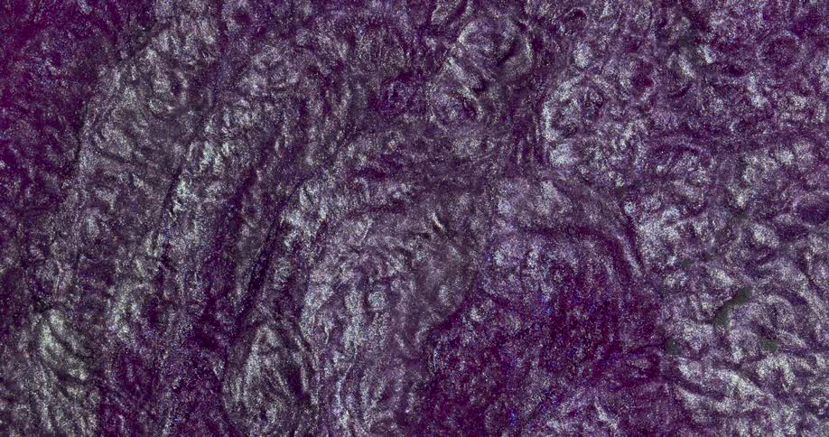 Moving liquid glitter inks creating a wavy metallic abstract background