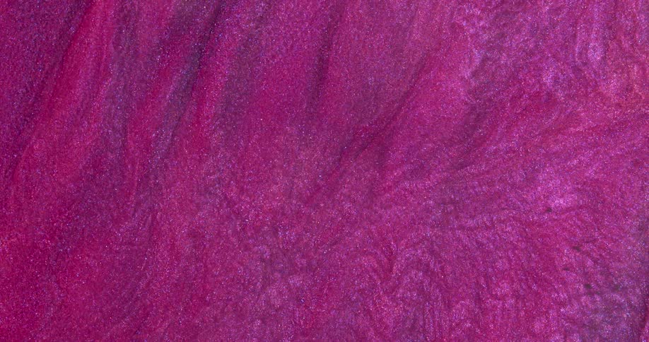 Macro close up of swirling metallic shimmer inks
