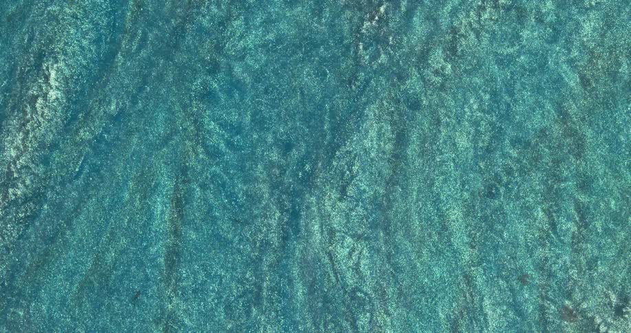 Macro close up of swirling metallic shimmer inks