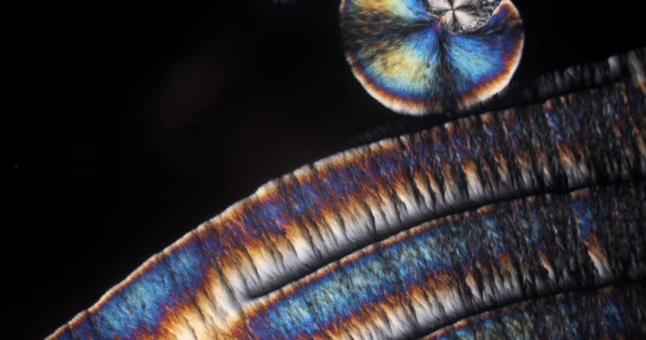 Abstract expanding crystals of chemical under the microscope