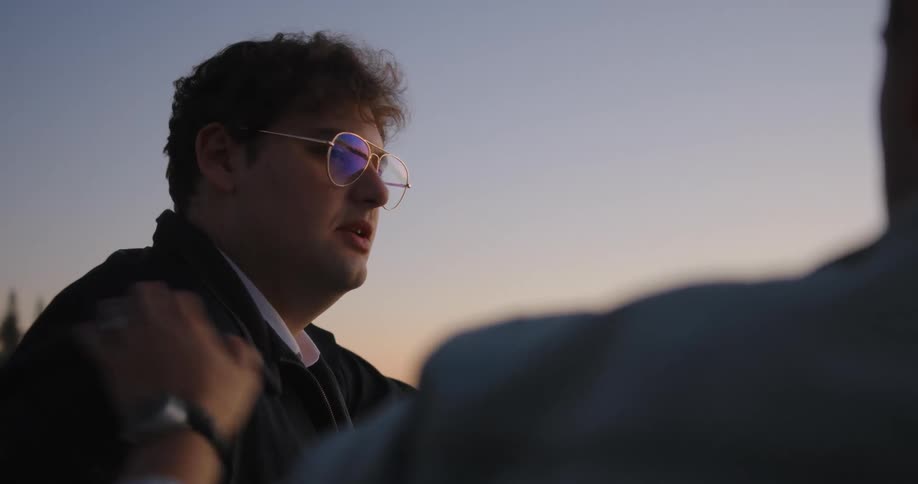 Portrait of two men conversing at sunrise