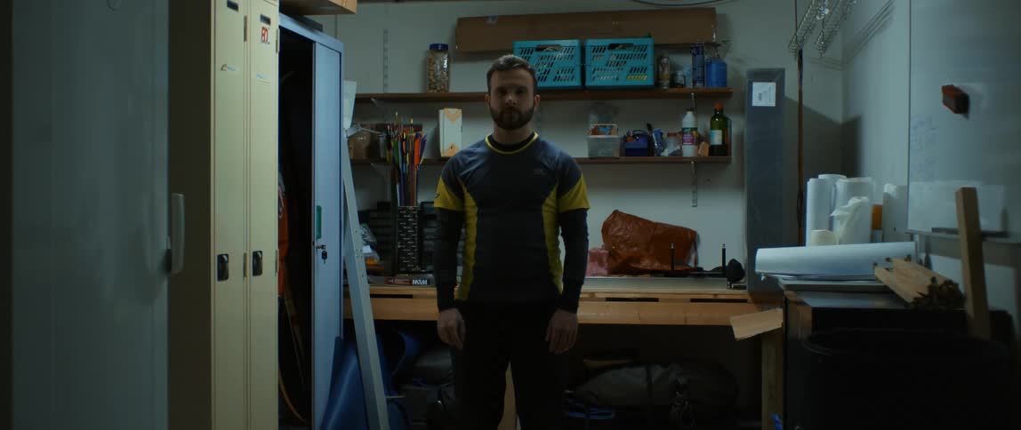 A man standing with a straight face indoor