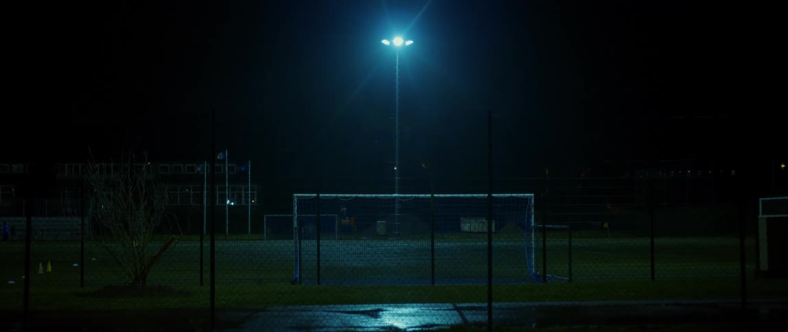 The soccer field is empty at night