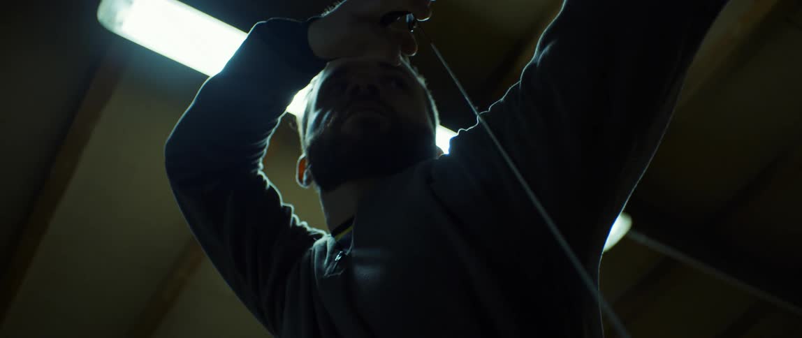 A man pulls on the string as he shoots an arrow from a bow during archery practice