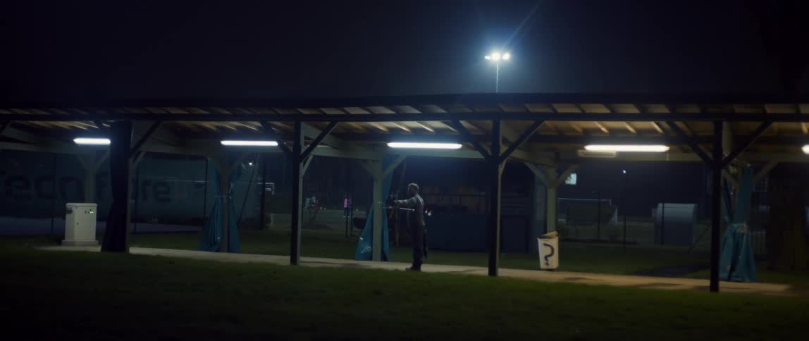 Archer prepares to make a shot with bow and arrow at night