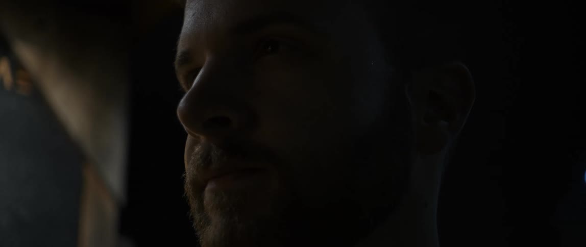 Face of a man staring at the distance at night