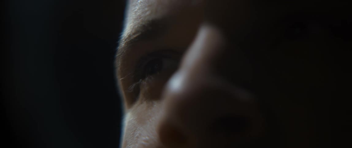 A male human face with reflections at the extremities