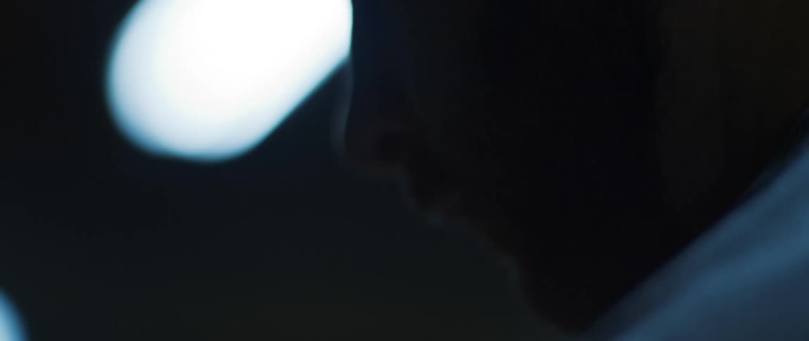 Portrait of a man in a dark indoor setting