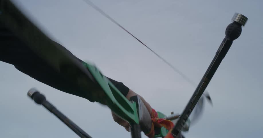Hand of a man holding a bow and arrow