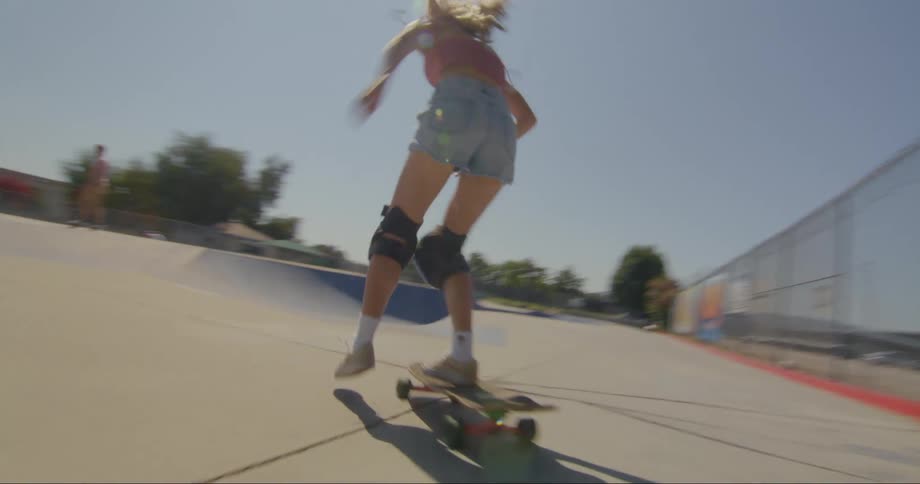 Young blonde woman skateboarding in an openair skatepark