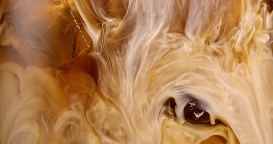 Cream poured into iced coffee