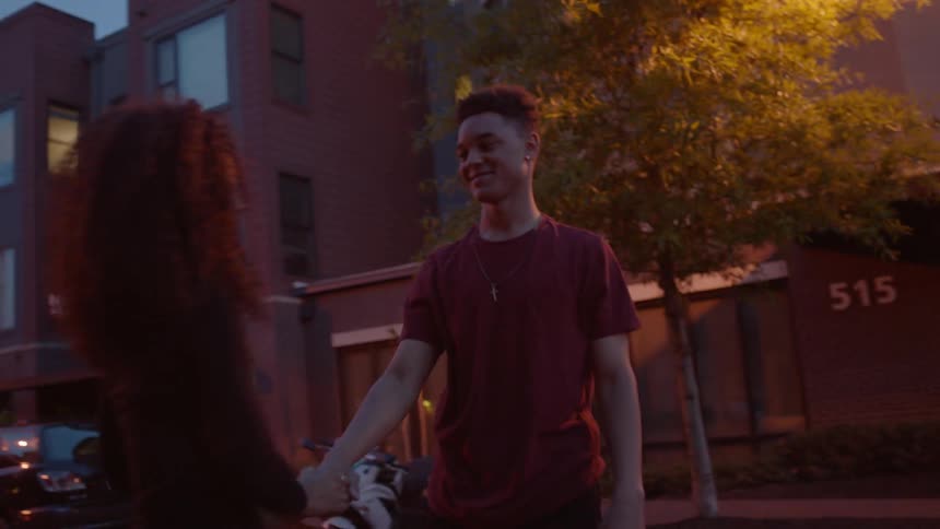 A man and woman dance in the street at dawn