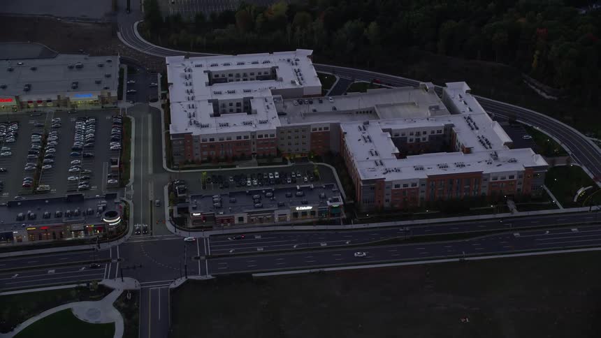 Aerial view of urban areas and buildings with vehicles on the roads