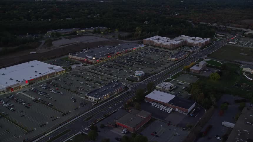 Aerial view of public places with various parked cars and others in motion