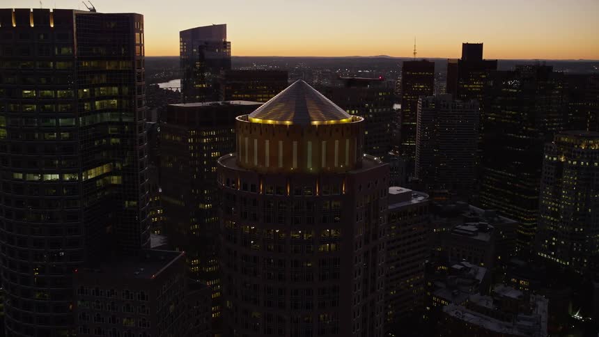 An aerial of skyscrapers in an urban area at dusk