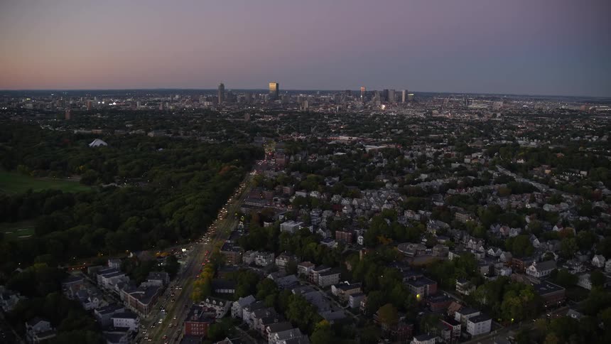 Aerial view of city streets skyline and buildings at dusk