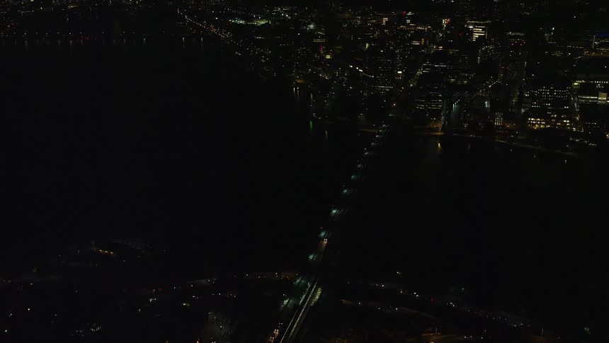 A bridge over a river in the city at night