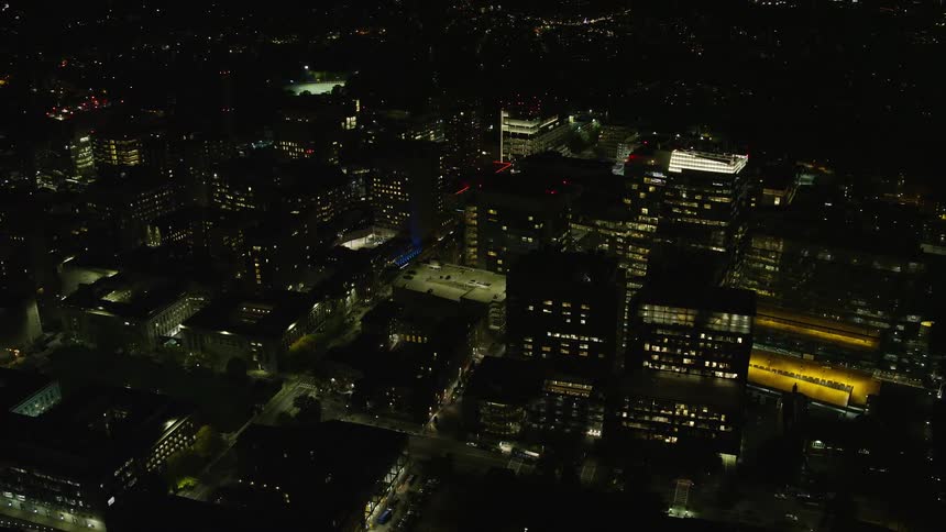 A city with residential buildings with floor lights on at night
