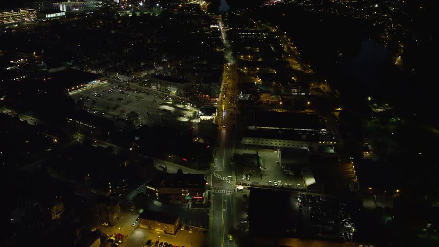 Traffic moves along highway crossing through city at night