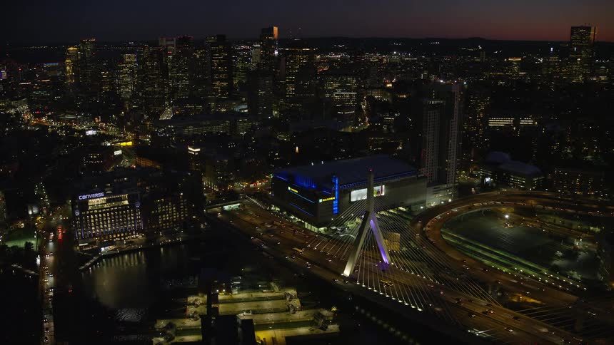 Aerial of buildings and moving cars in a city at night