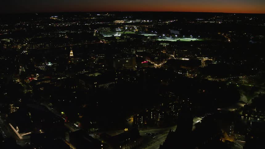 A city on a dark morning with house lights on