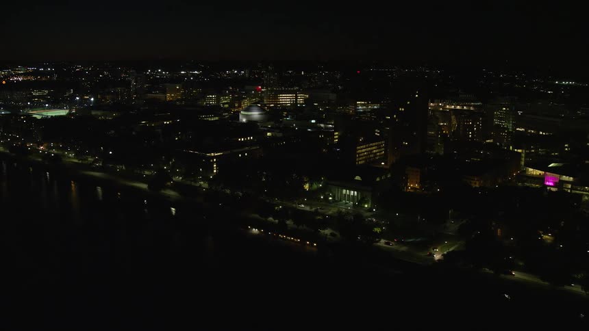 A night city with cars passing on the streets