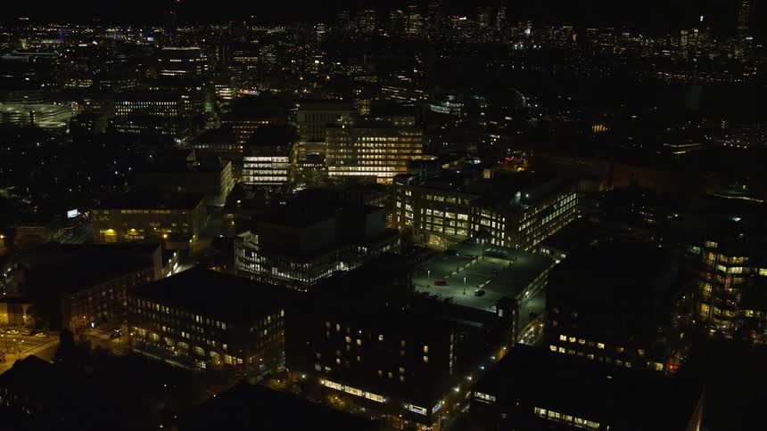 A night city where the sources of light are homes and street lamps