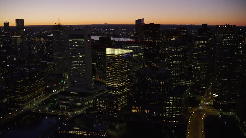 Aerial view of a citys downtown area skyscrapers at dusk