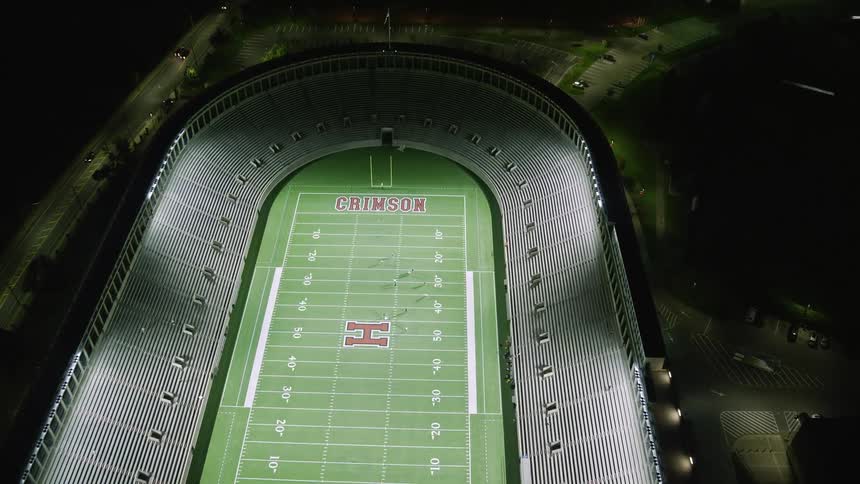 Aerial nighttime view of a stadium in the midst of the city
