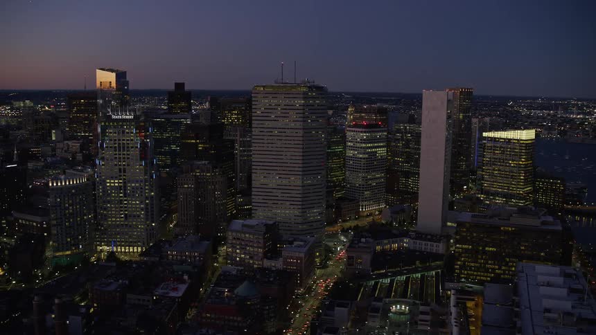 Several tall office buildings in a large city in the morning