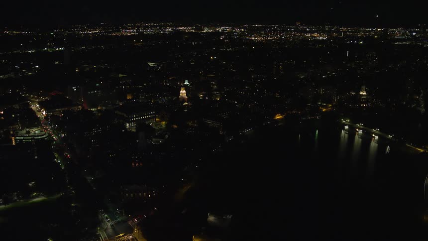 Aerial of buildings and moving cars in a metropolitan area at night
