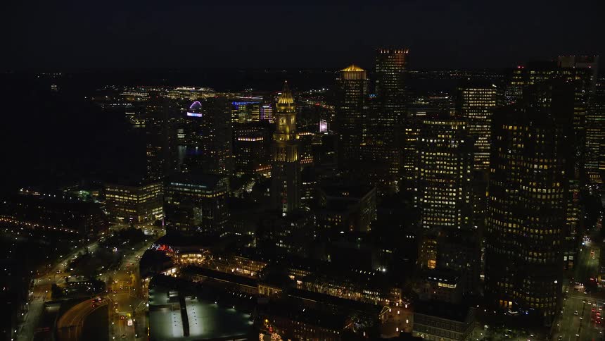 Aerial of buildings and skyscrapers in a city at night