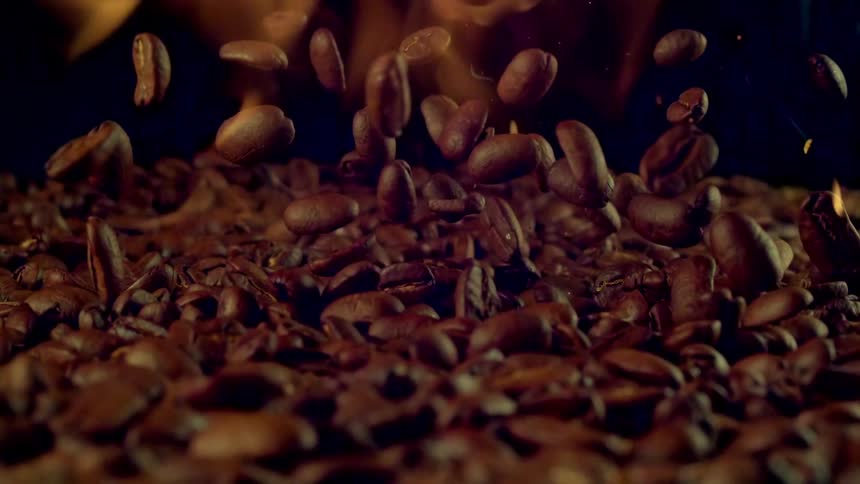 Roasted coffee beans jump surrounded in flames