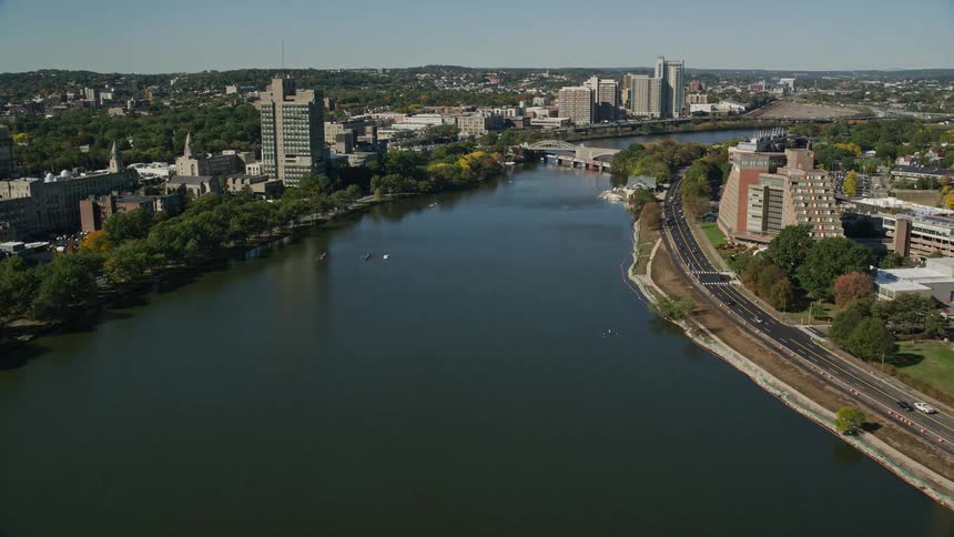 A wide river that is in the middle of a city dividing the lands