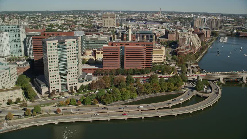 Aerial view of a downtown area of a city and a highway bridge crossing a river