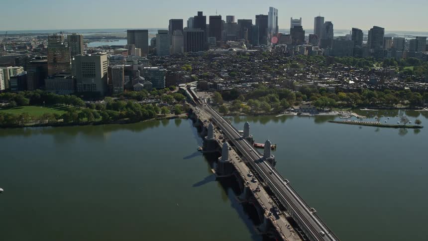 A huge bridge that crosses a large lake to a large city