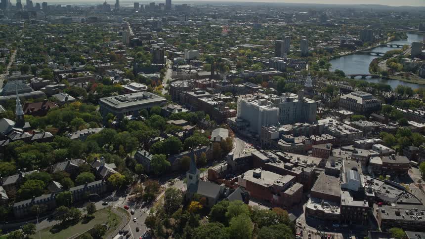 A suburb of a city with lots of trees and a river