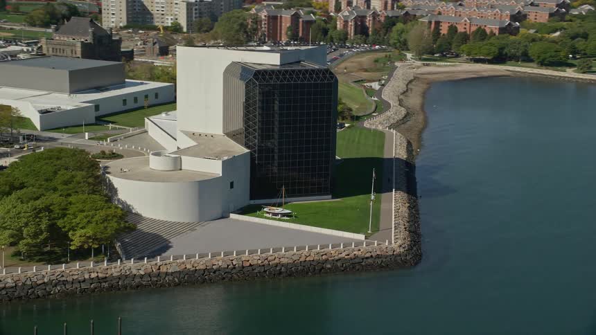 Exterior architecture of a waterfront building with a mirrored glass design