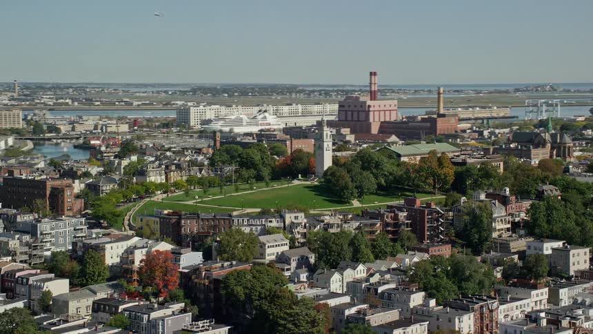 Aerial panorama of an urban city with a peak featuring a church tower
