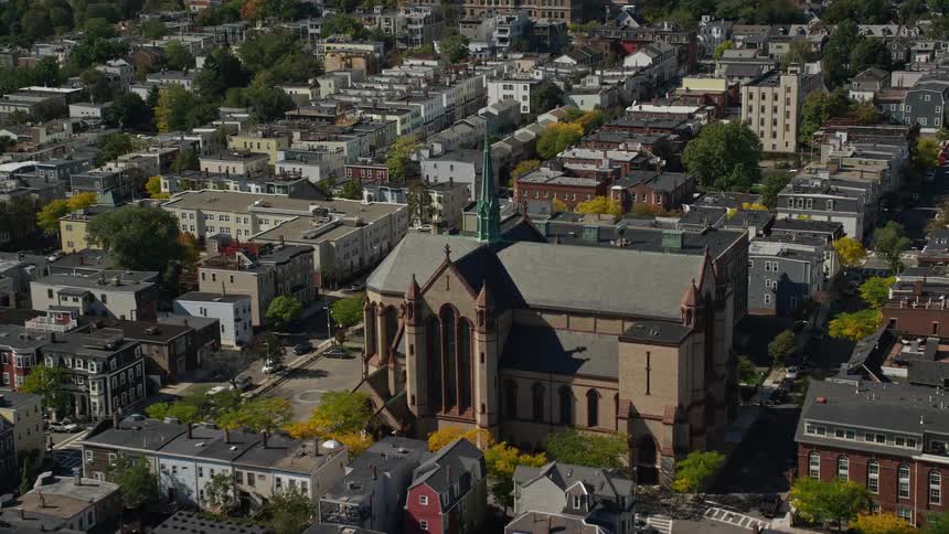 Trees starting to change color in fall surround church in residential neighborhood