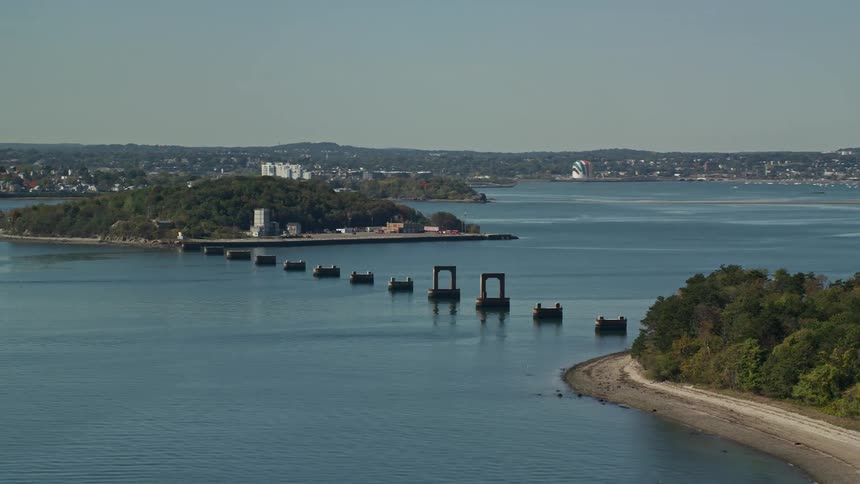 An aerial view of structures between two islands near a suburban port