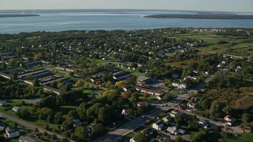An aerial view of a suburban neighborhood by a lake