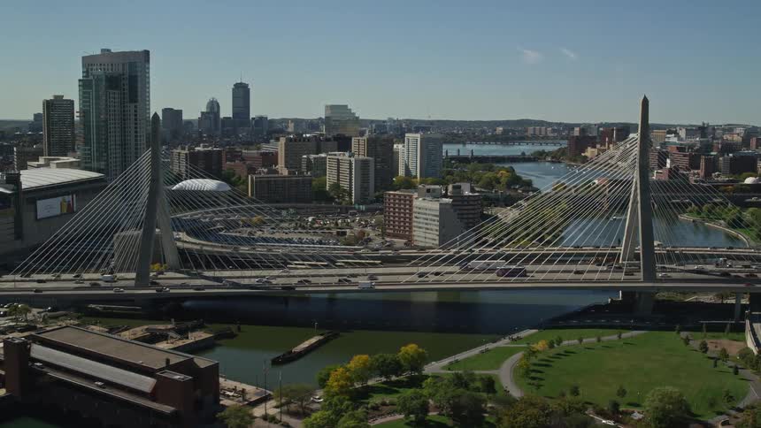 Traffic crosses suspension bridge near marina and downtown in early fall