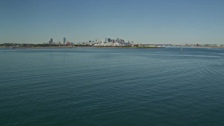 A metropolitan city in the background surrounded by a huge sea