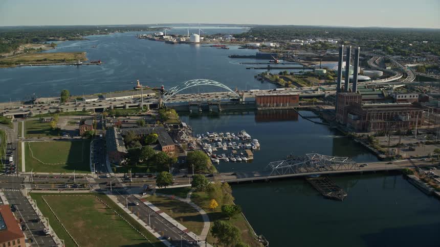 Aerial view of a pier and a bridge in a river next to a town