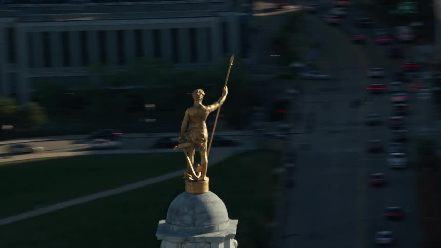 The tower has a golden statue at the top