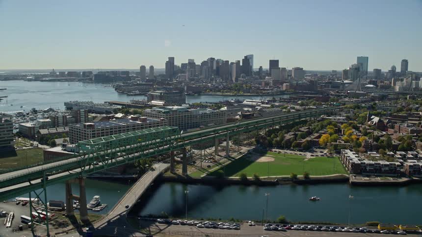 A large city with a river connected to a sea and a bridge running over it