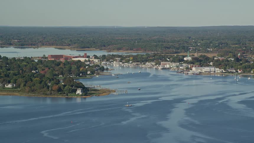 Homes line the peninsula as boats pass by