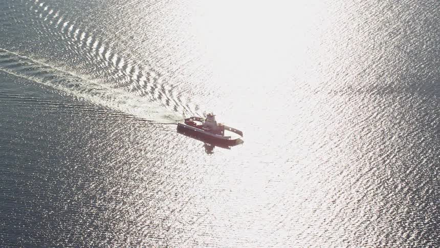 Aerial view of a boat sailing in the ocean at daytime